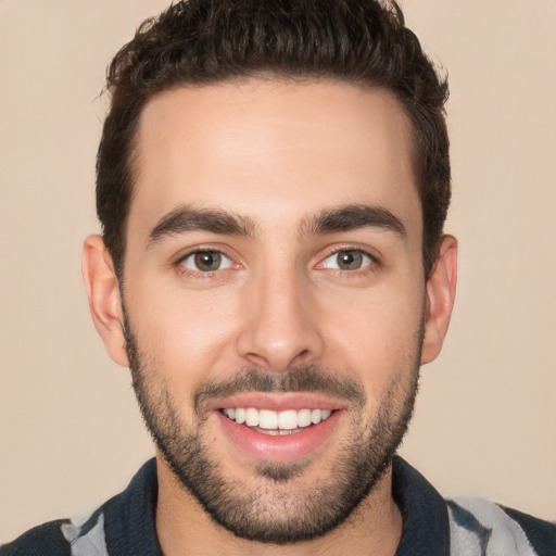 Joyful white young-adult male with short  black hair and brown eyes