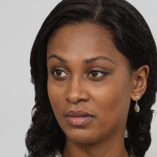 Neutral black young-adult female with long  brown hair and brown eyes