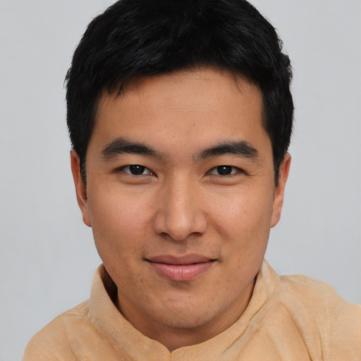 Joyful asian young-adult male with short  black hair and brown eyes
