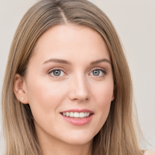 Joyful white young-adult female with long  brown hair and grey eyes