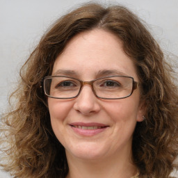 Joyful white adult female with long  brown hair and brown eyes