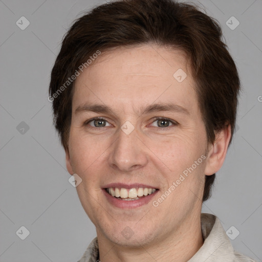 Joyful white adult male with short  brown hair and grey eyes