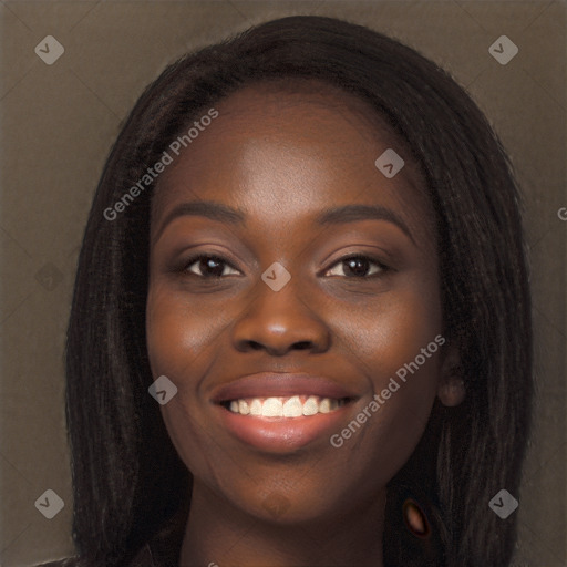 Joyful black young-adult female with long  black hair and brown eyes