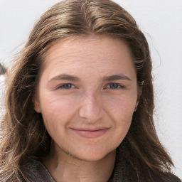 Joyful white adult female with long  brown hair and grey eyes