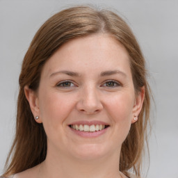 Joyful white young-adult female with medium  brown hair and grey eyes