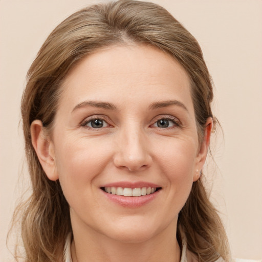 Joyful white young-adult female with medium  brown hair and grey eyes