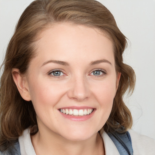 Joyful white young-adult female with medium  brown hair and blue eyes