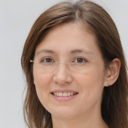 Joyful white adult female with long  brown hair and brown eyes