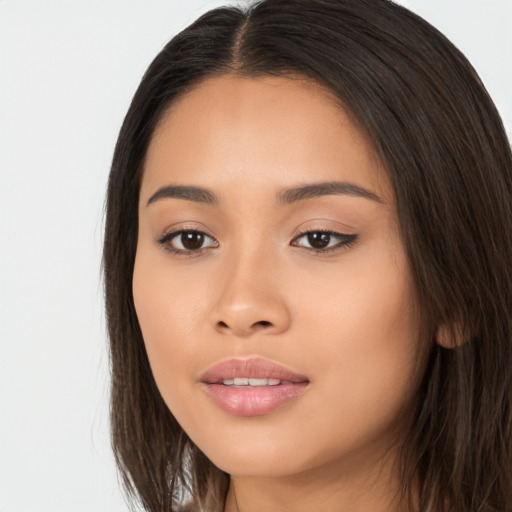 Joyful latino young-adult female with long  brown hair and brown eyes