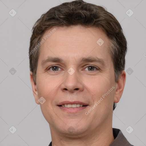 Joyful white adult male with short  brown hair and grey eyes