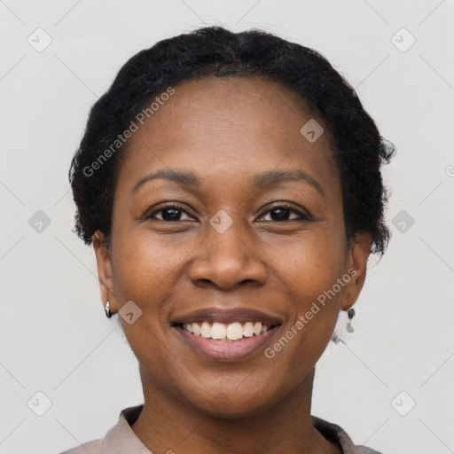 Joyful black young-adult female with short  black hair and brown eyes