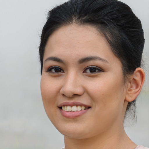 Joyful asian young-adult female with medium  brown hair and brown eyes