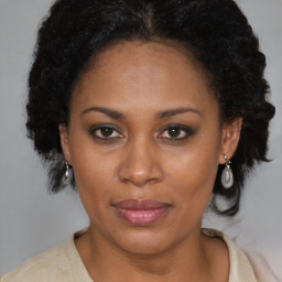 Joyful black adult female with medium  brown hair and brown eyes