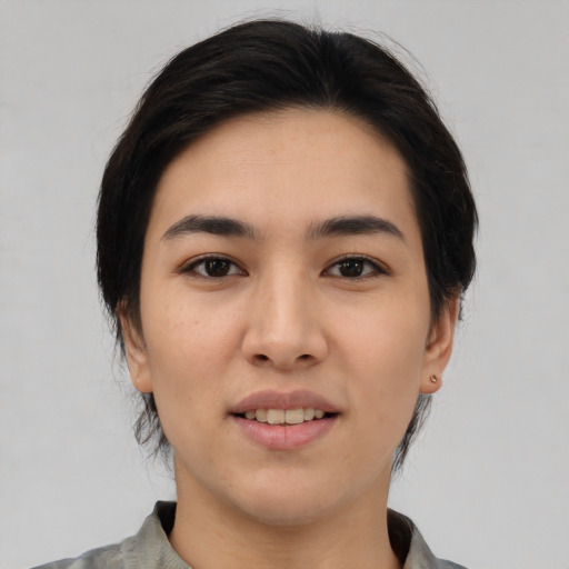 Joyful white young-adult female with medium  black hair and brown eyes