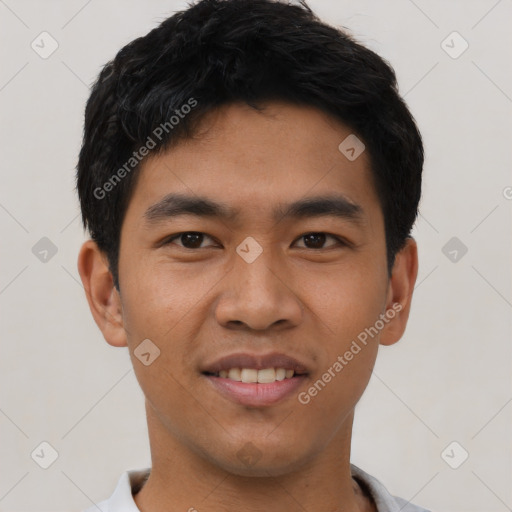 Joyful asian young-adult male with short  black hair and brown eyes