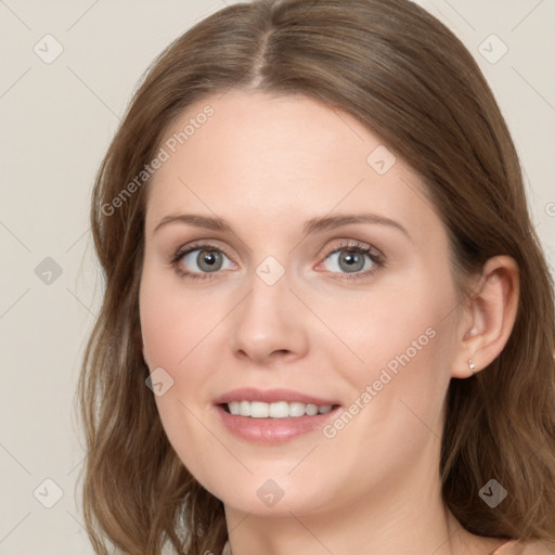 Joyful white young-adult female with long  brown hair and blue eyes