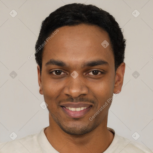 Joyful black young-adult male with short  black hair and brown eyes