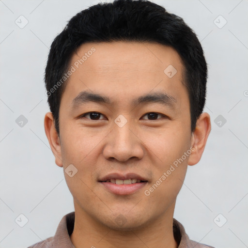 Joyful asian young-adult male with short  black hair and brown eyes