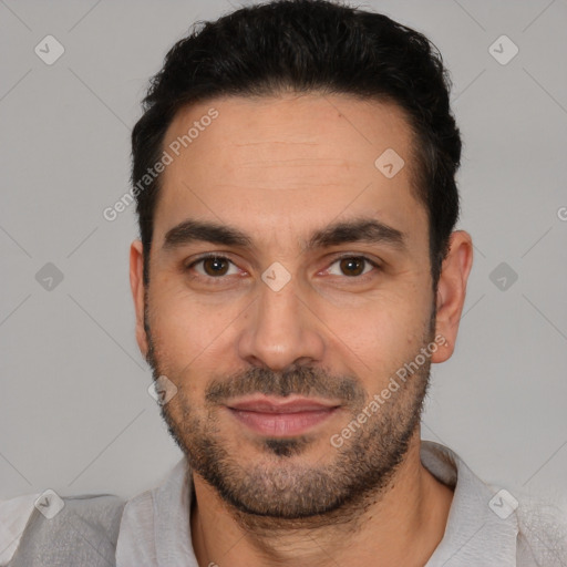 Joyful white young-adult male with short  black hair and brown eyes