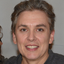 Joyful white adult male with medium  brown hair and brown eyes