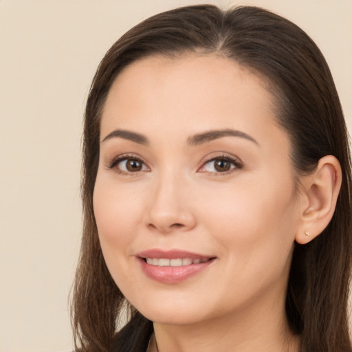 Joyful white young-adult female with long  brown hair and brown eyes