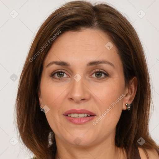 Joyful white adult female with long  brown hair and brown eyes