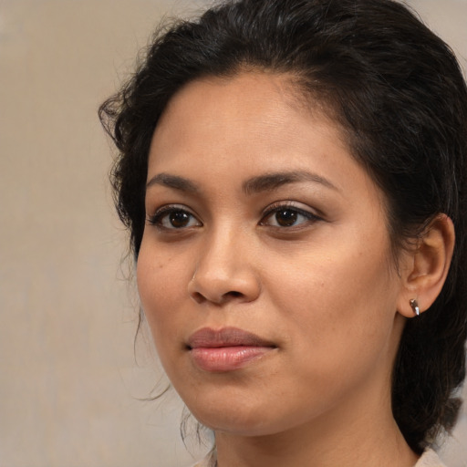 Joyful latino young-adult female with medium  brown hair and brown eyes