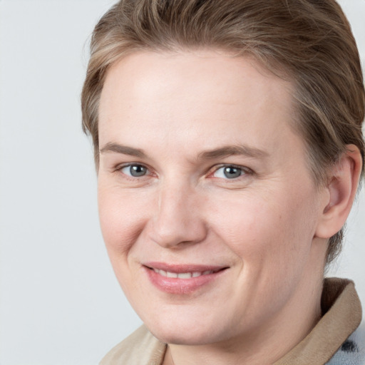 Joyful white adult female with medium  brown hair and grey eyes