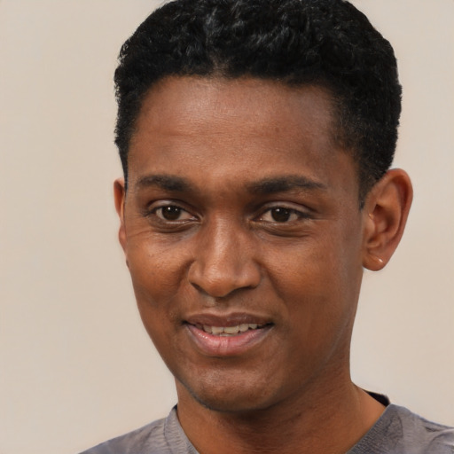 Joyful black young-adult male with short  black hair and brown eyes