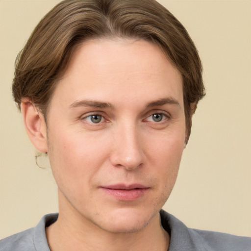 Joyful white young-adult female with short  brown hair and grey eyes