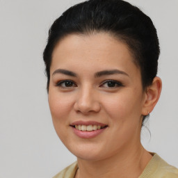 Joyful latino young-adult female with medium  brown hair and brown eyes