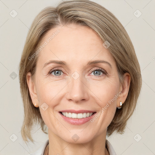 Joyful white adult female with medium  brown hair and grey eyes