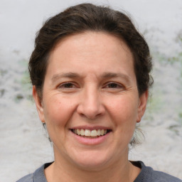 Joyful white adult female with short  brown hair and grey eyes