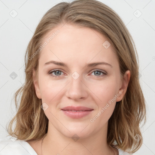 Joyful white young-adult female with medium  brown hair and blue eyes