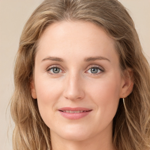 Joyful white young-adult female with long  brown hair and green eyes