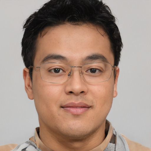 Joyful asian adult male with short  brown hair and brown eyes