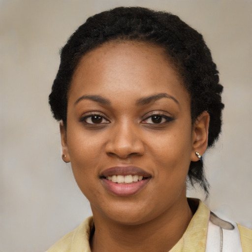 Joyful black young-adult female with short  black hair and brown eyes