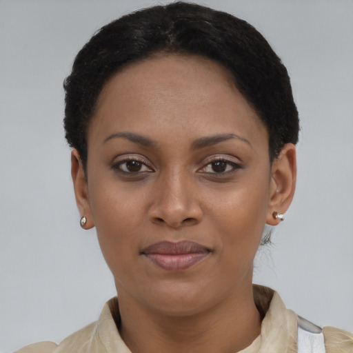 Joyful black young-adult female with short  black hair and brown eyes