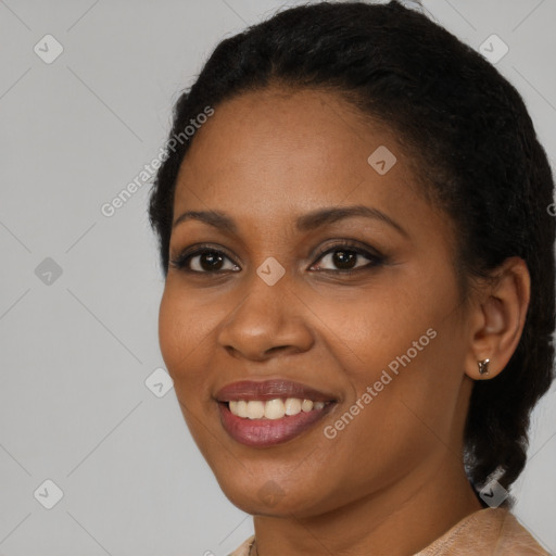 Joyful black young-adult female with short  black hair and brown eyes