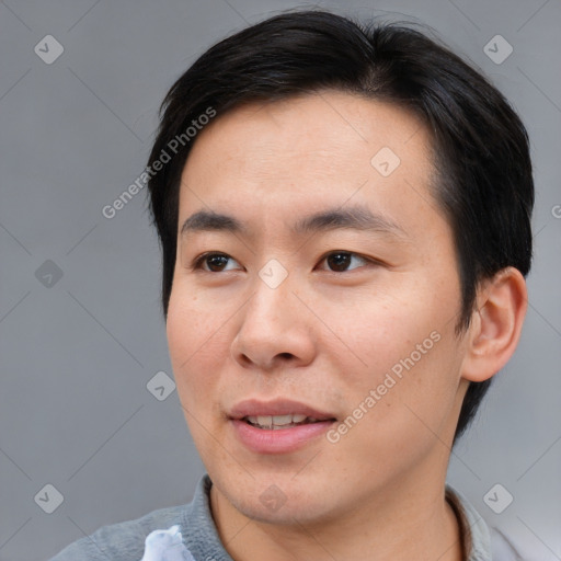 Joyful asian young-adult male with short  brown hair and brown eyes