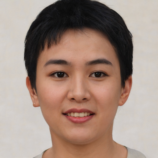Joyful asian young-adult female with short  black hair and brown eyes