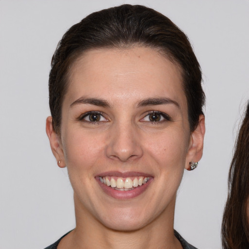 Joyful white young-adult female with short  brown hair and brown eyes