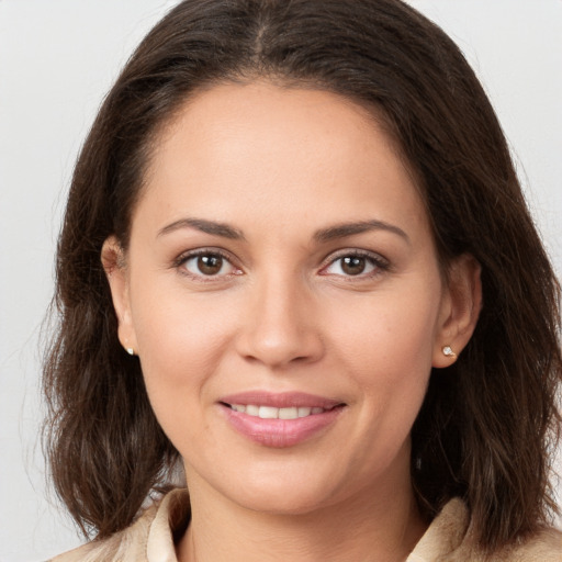 Joyful white young-adult female with medium  brown hair and brown eyes