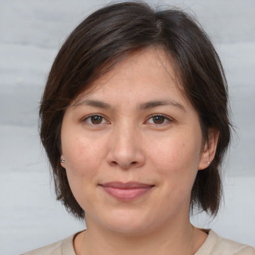 Joyful white adult female with medium  brown hair and brown eyes