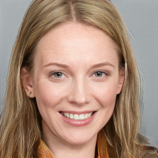 Joyful white young-adult female with long  brown hair and blue eyes