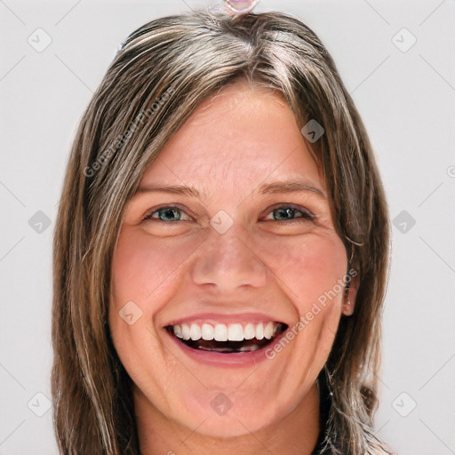 Joyful white young-adult female with long  brown hair and blue eyes