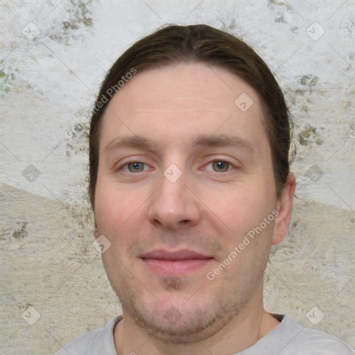 Joyful white young-adult male with short  brown hair and grey eyes