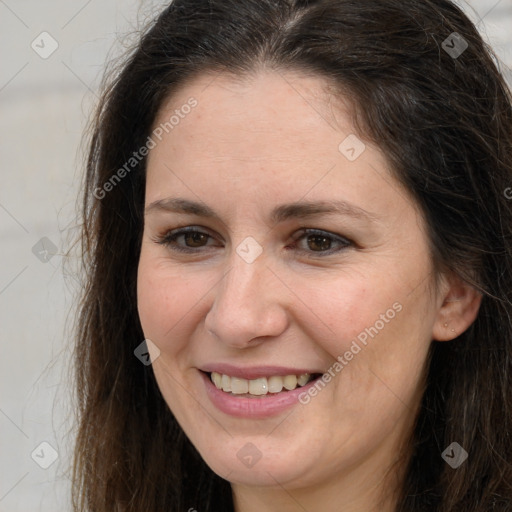 Joyful white adult female with long  brown hair and brown eyes