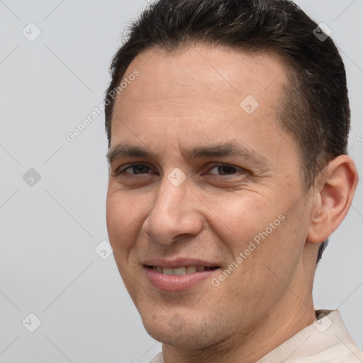 Joyful white adult male with short  brown hair and brown eyes