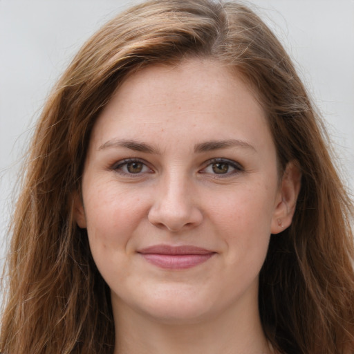 Joyful white young-adult female with long  brown hair and grey eyes